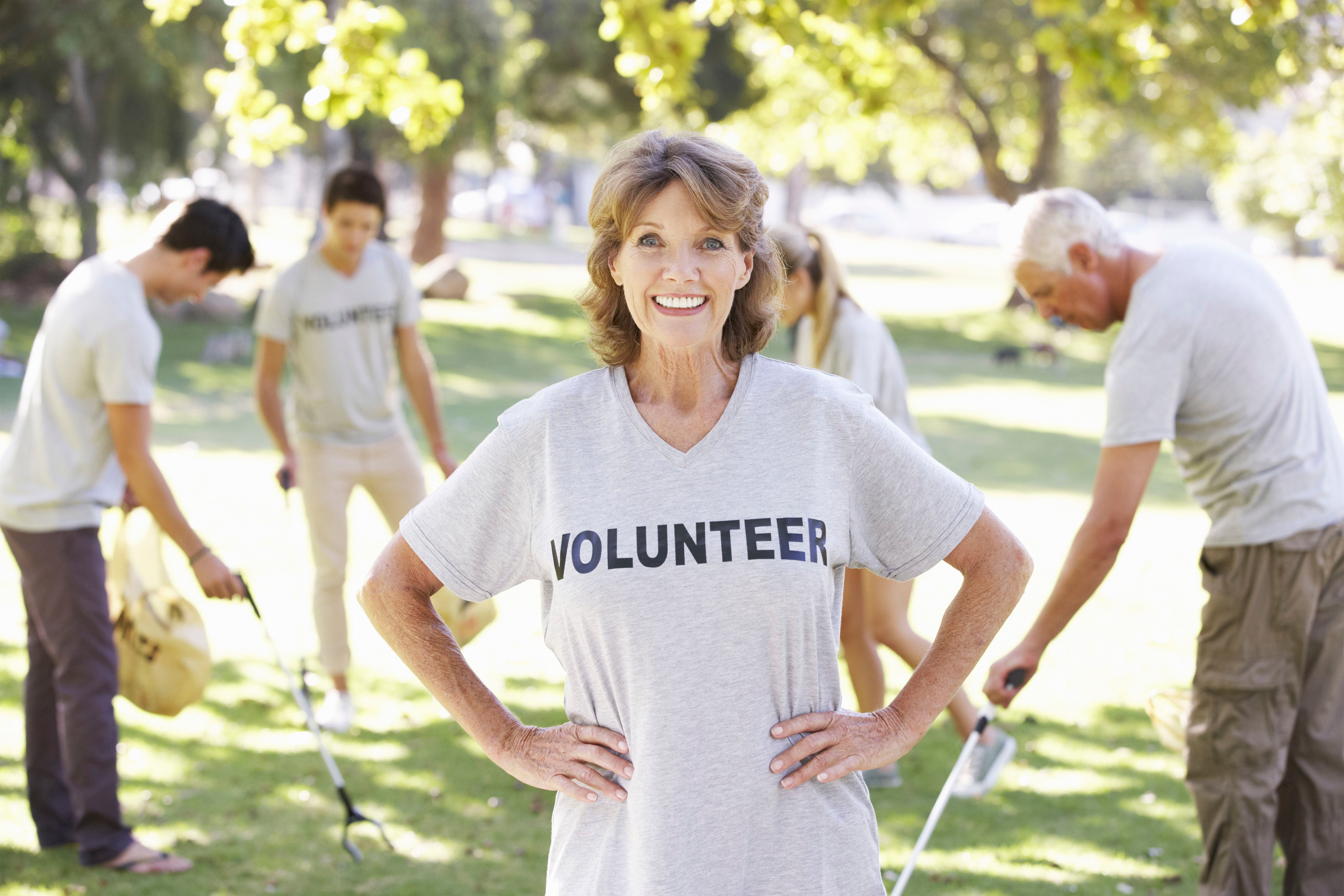 senior woman wearing volunteer shirt